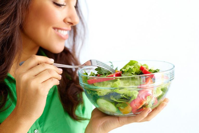 A woman eating a healthy food